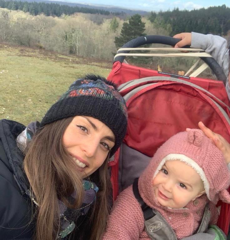 Daniella and a toddler on a walk through the woods